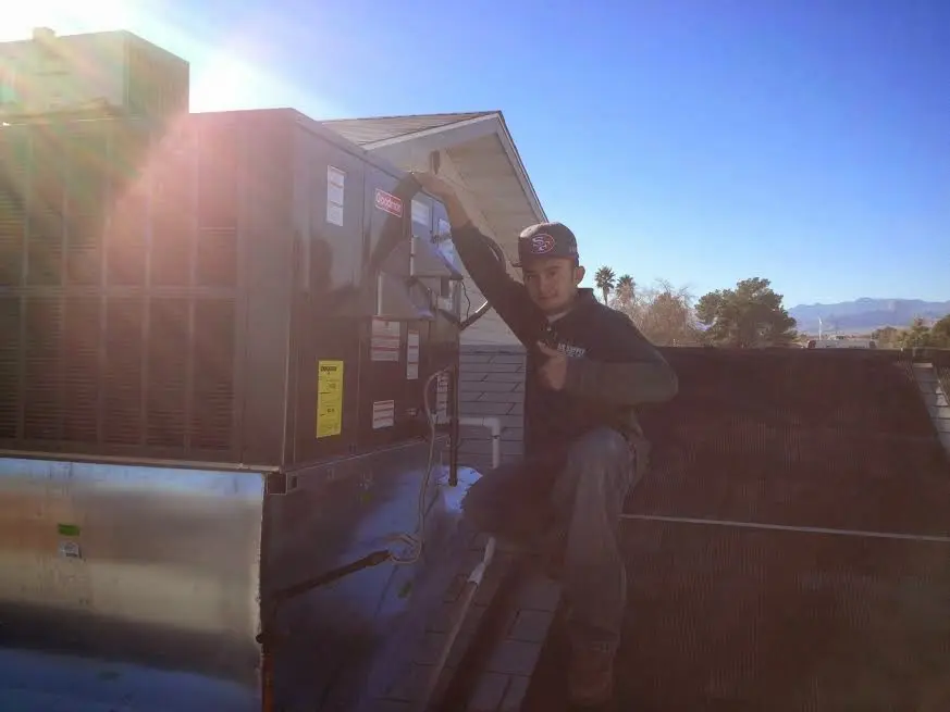 HVAC technician performing HVAC Inspection on a rooftop unit in Island Lake